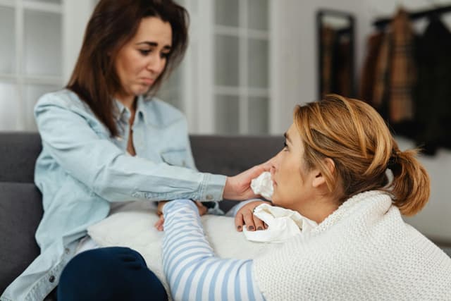 Woman wiping the tears of a crying woman